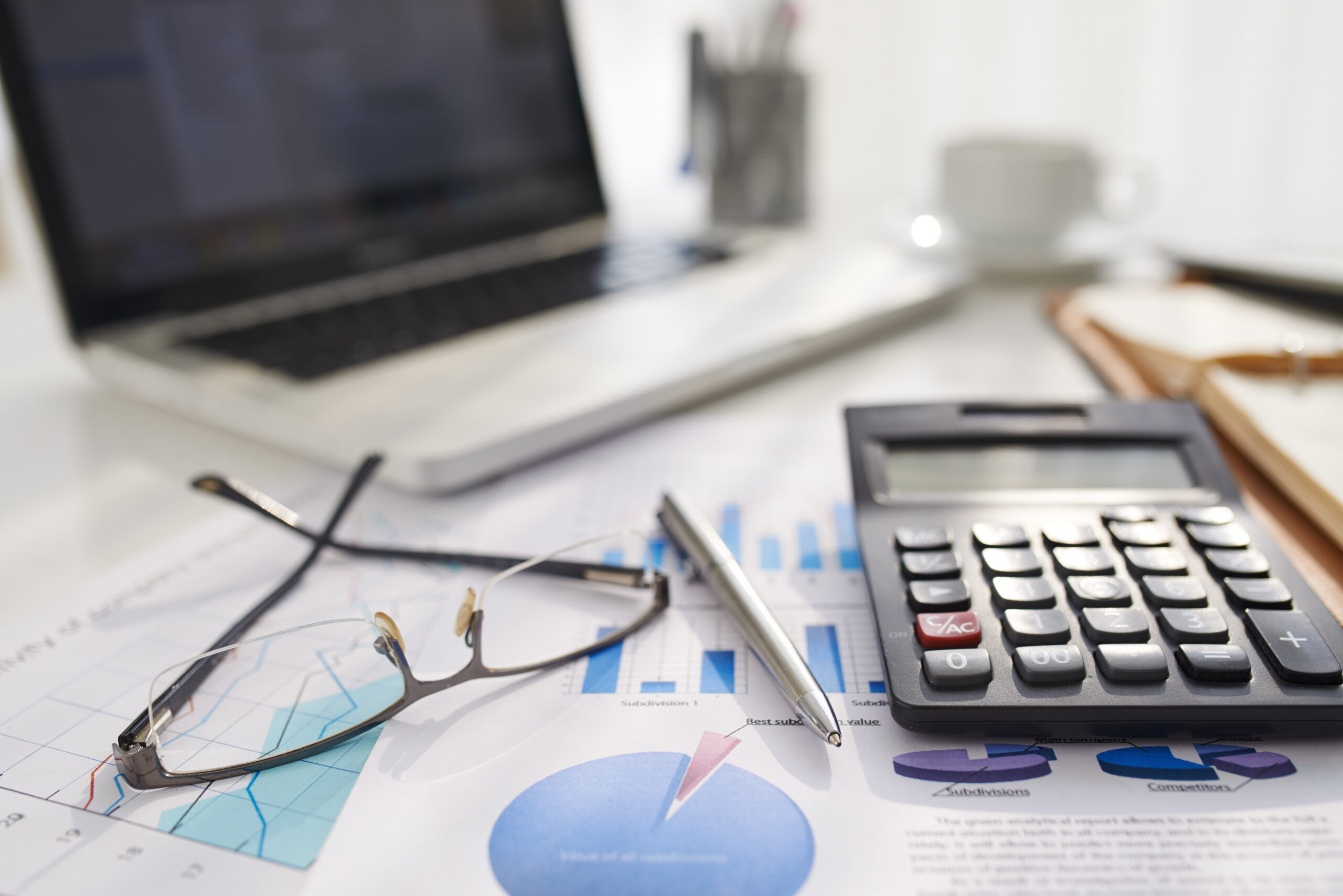 Business document, calculator and glasses on table of entrepreneur